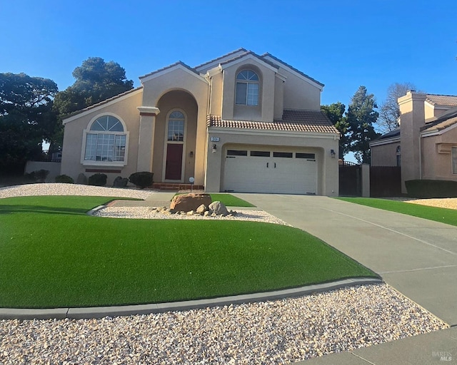 1006 Armsby Way, Suisun City, CA 94585 - mediterranean / spanish-style house with stucco siding, concrete driveway, a garage, a front lawn, and a tiled roof