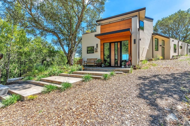 back of property featuring stucco siding