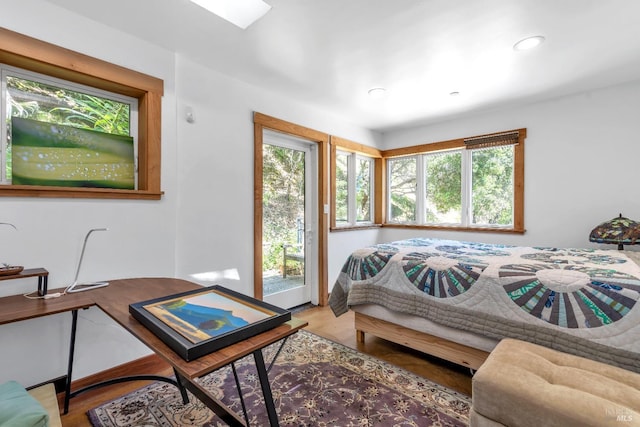 bedroom with multiple windows, recessed lighting, and access to exterior