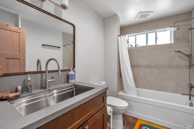 full bathroom featuring vanity, shower / bath combo, toilet, and visible vents