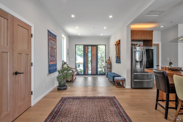 foyer with baseboards, recessed lighting, and light wood-style flooring