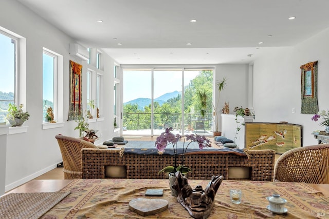dining area with plenty of natural light, recessed lighting, a mountain view, and wood finished floors