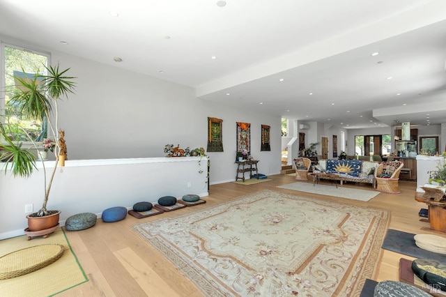 exercise room with plenty of natural light, recessed lighting, and wood finished floors