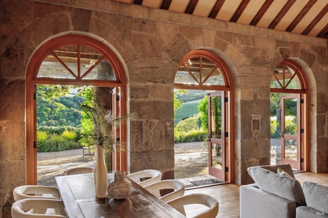 doorway to outside featuring vaulted ceiling and wood finished floors