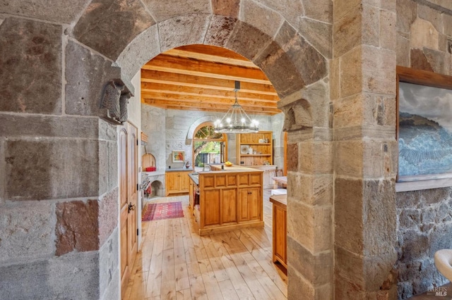 bathroom with beamed ceiling, vanity, hardwood / wood-style flooring, and a notable chandelier