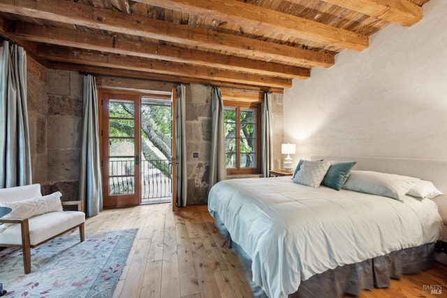 bedroom featuring wood-type flooring, beamed ceiling, access to outside, and wooden ceiling