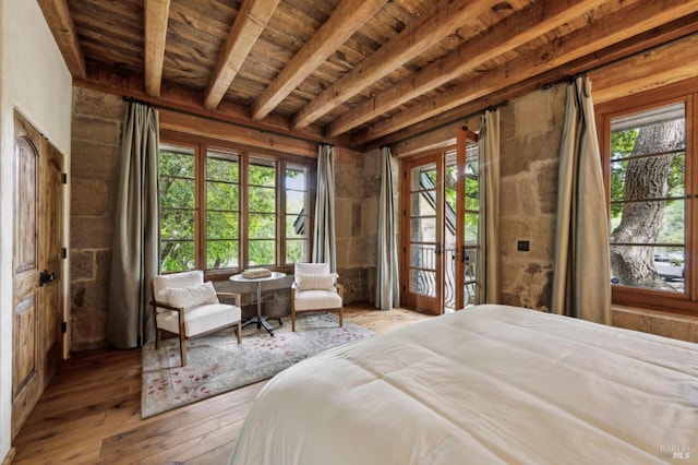 bedroom featuring hardwood / wood-style floors, wooden ceiling, beamed ceiling, and access to exterior