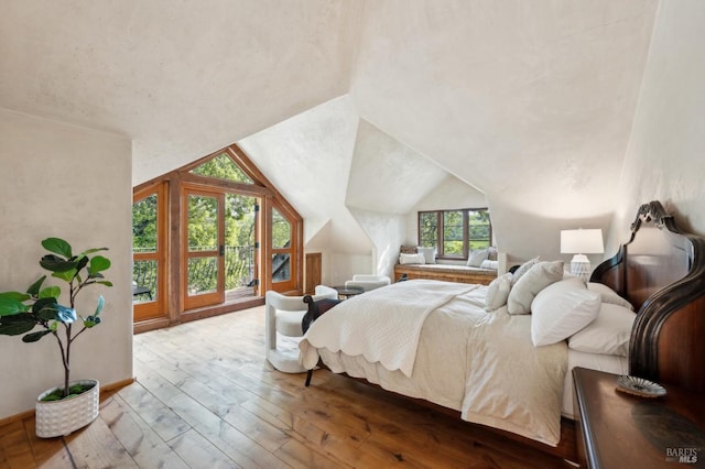 bedroom featuring lofted ceiling and wood-type flooring