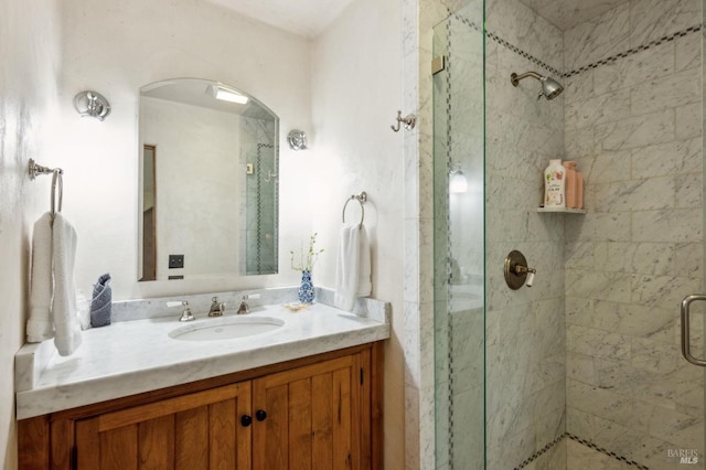 full bath featuring a shower stall and vanity