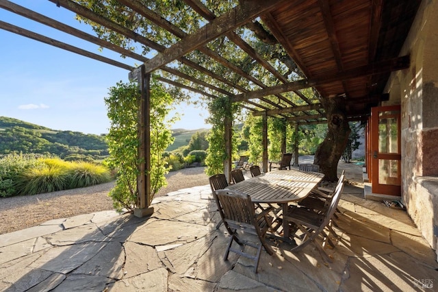 view of patio featuring a pergola and outdoor dining space