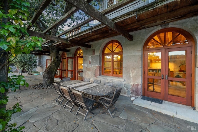 view of patio / terrace featuring a pergola, french doors, and outdoor dining space