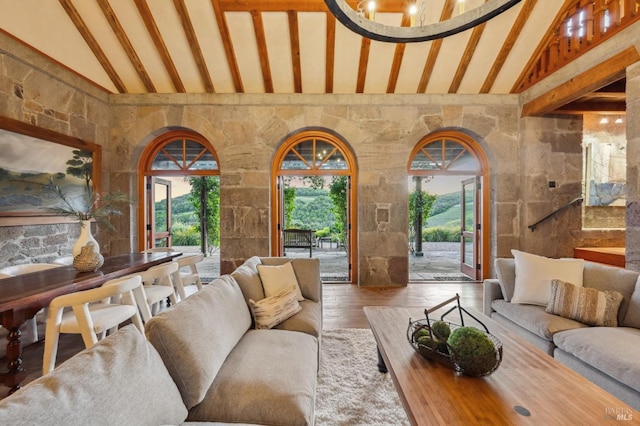 living room featuring beamed ceiling, wood finished floors, and high vaulted ceiling