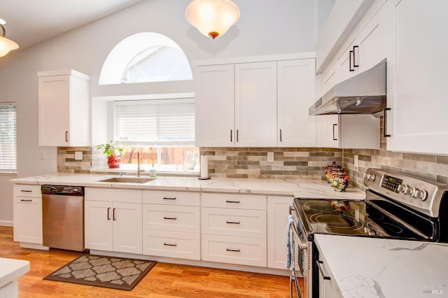 kitchen featuring white cabinets, under cabinet range hood, a sink, and appliances with stainless steel finishes