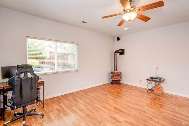 office featuring visible vents, a ceiling fan, baseboards, and light wood-style floors