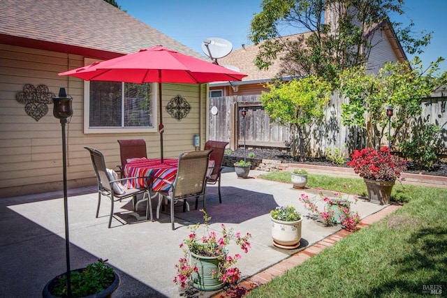 view of patio with fence and outdoor dining area