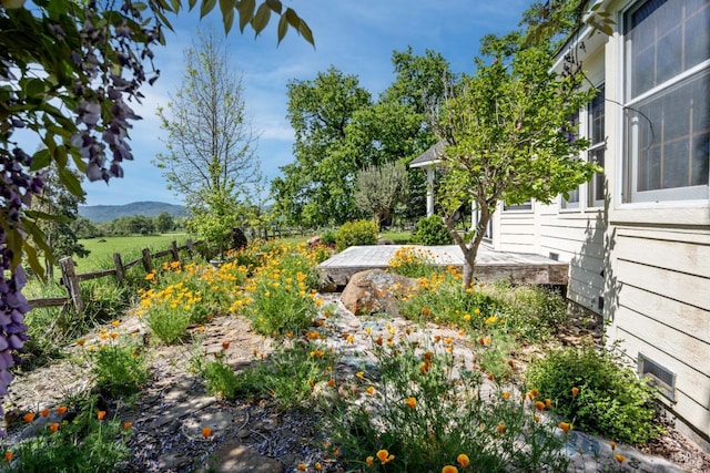 view of yard featuring a mountain view and fence