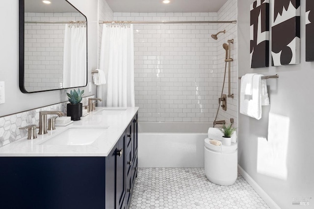 bathroom featuring double vanity, shower / tub combo with curtain, tile patterned flooring, and a sink