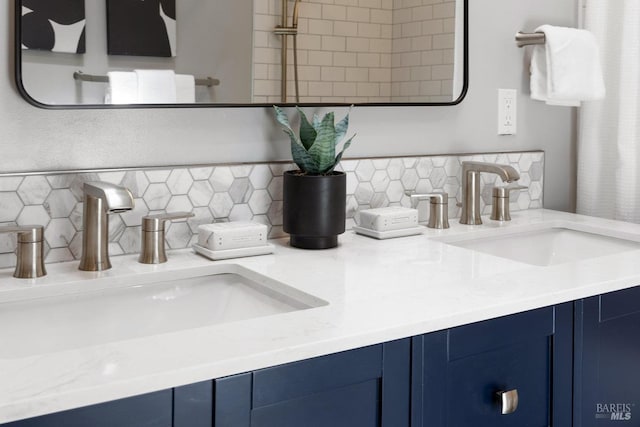room details with double vanity, tasteful backsplash, and a sink