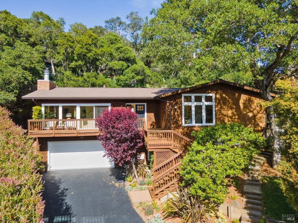 7 Madrono Ave, Corte Madera, CA 94925 - view of front of property with stairway, an attached garage, asphalt driveway, and a chimney