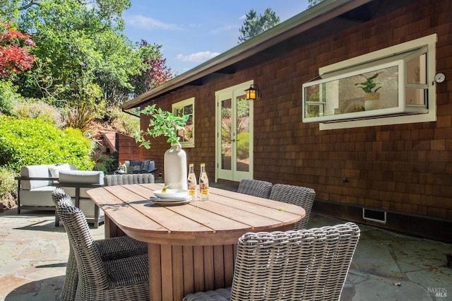 view of patio / terrace with grilling area, outdoor dining area, and visible vents