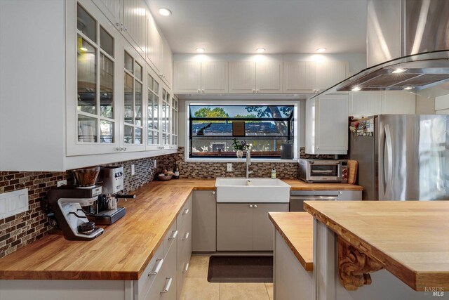 1416 F St, Napa, CA 94559 - kitchen with wood counters, exhaust hood, freestanding refrigerator, and tasteful backsplash