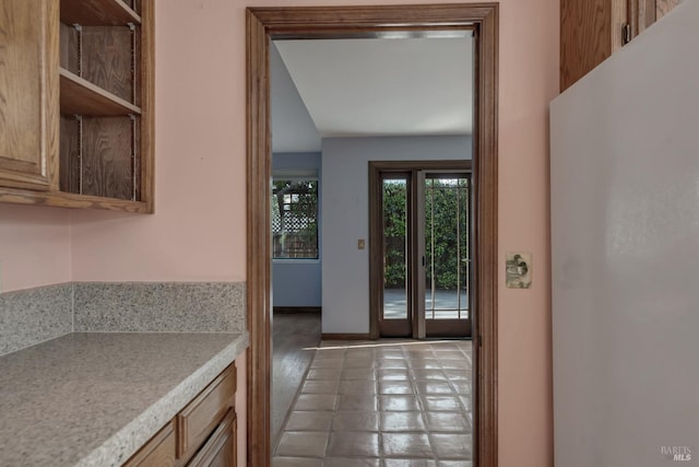 doorway to outside with baseboards