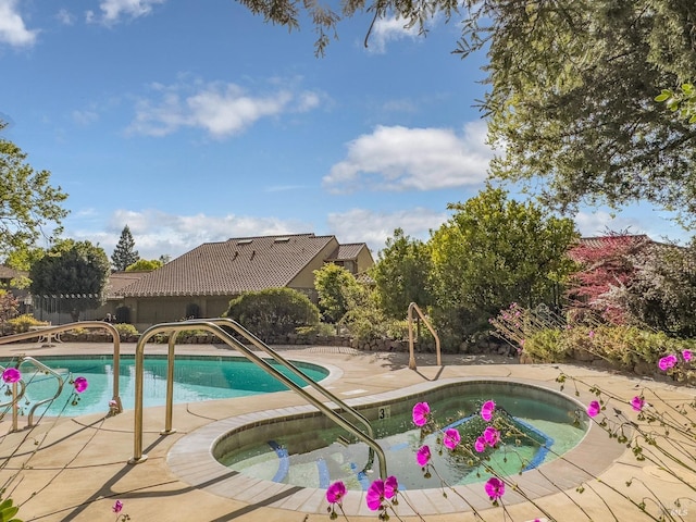 outdoor pool featuring a patio area and fence