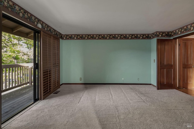 carpeted spare room with plenty of natural light and baseboards