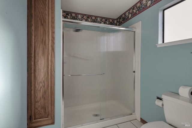 full bathroom with tile patterned floors, baseboards, a shower stall, and toilet