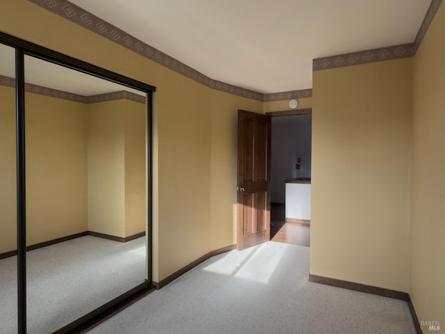 interior space featuring carpet floors and baseboards