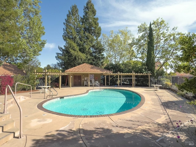 pool featuring a pergola, a patio, and fence