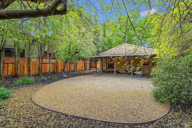 view of yard with fence and a patio area