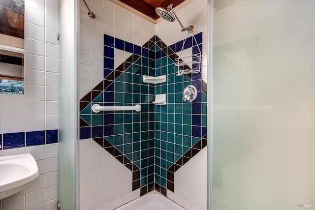 bathroom with a sink and a stall shower