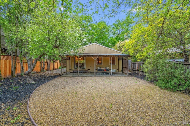 rear view of property with a patio area and a fenced backyard
