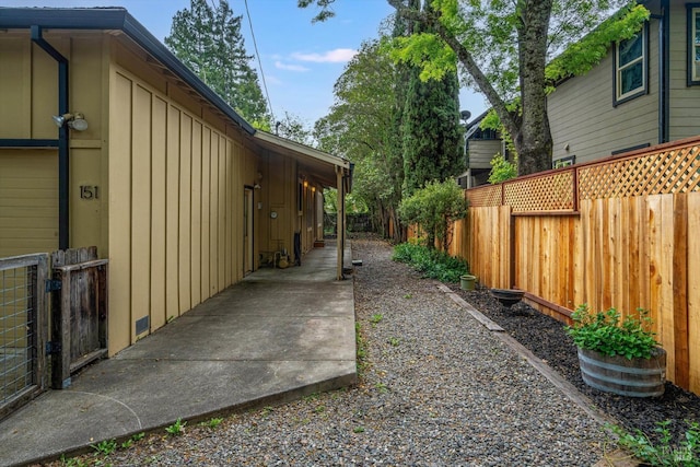 exterior space featuring board and batten siding and a fenced backyard