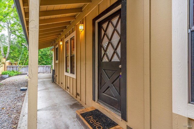 doorway to property featuring fence