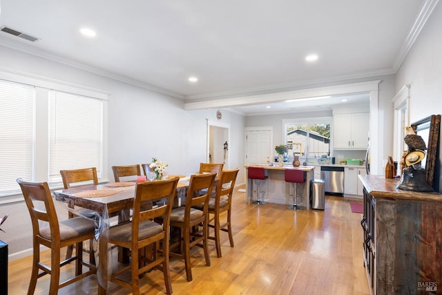 dining room with recessed lighting, ornamental molding, visible vents, and light wood-type flooring