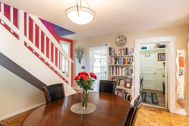 dining room with stairway and baseboards