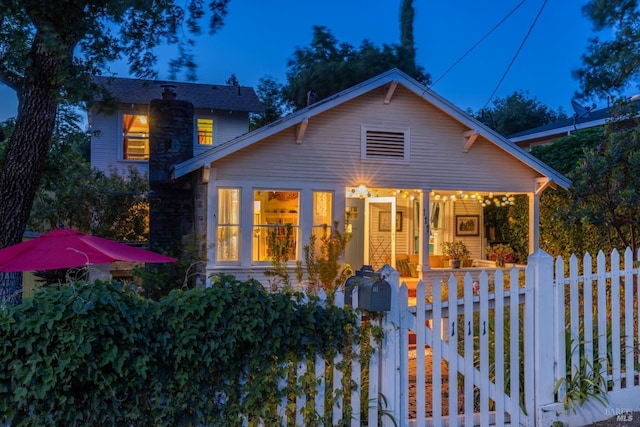 view of front of property featuring a porch and fence