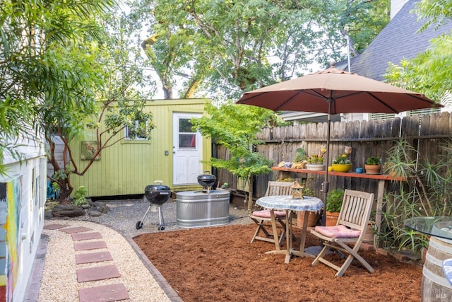 view of yard with an outdoor structure and fence