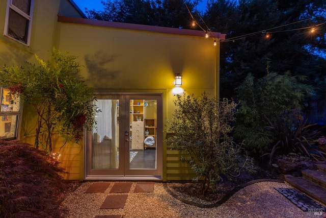 property entrance with french doors and stucco siding