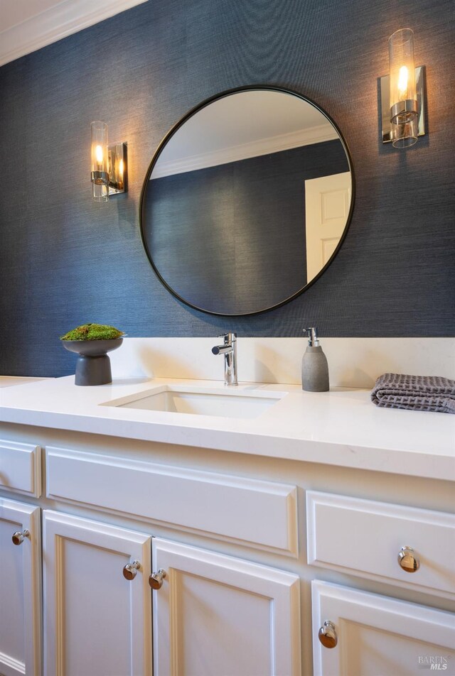 bathroom with crown molding and vanity