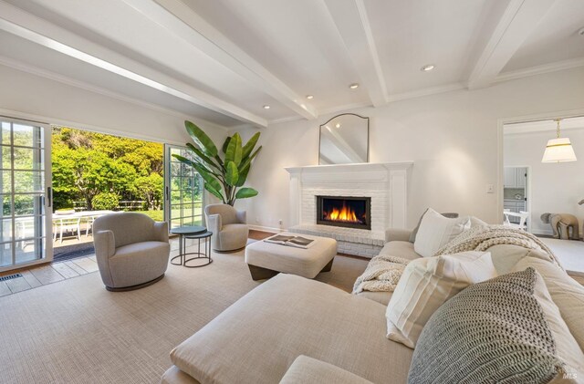 living room featuring wood finished floors, visible vents, beam ceiling, crown molding, and a fireplace