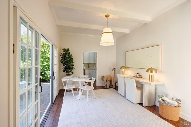 dining space with wood finished floors, beam ceiling, crown molding, and baseboards