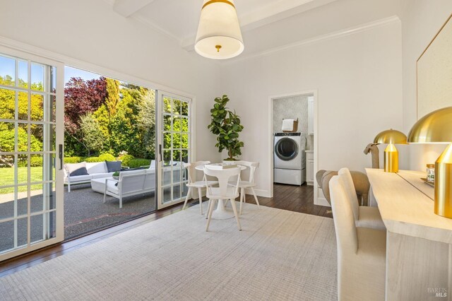 dining room with washer / dryer, crown molding, wood finished floors, and a wealth of natural light
