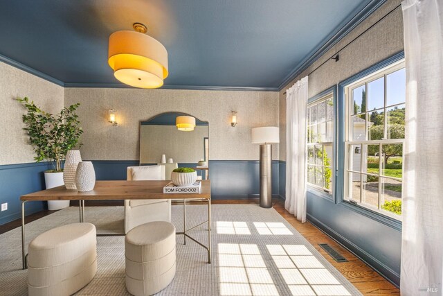 dining room with baseboards, ornamental molding, visible vents, and plenty of natural light