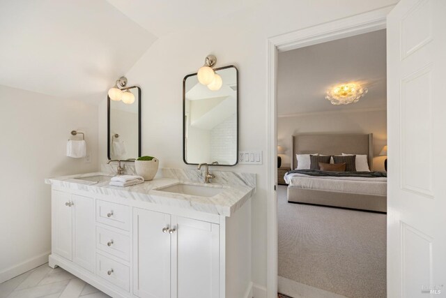 full bathroom featuring double vanity, ensuite bath, baseboards, and a sink