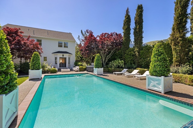 outdoor pool featuring a patio