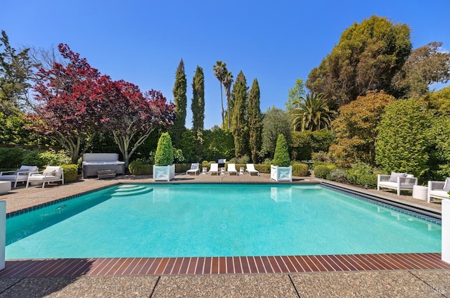 outdoor pool featuring a patio area