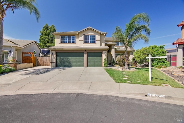 traditional-style home featuring fence, a front lawn, stucco siding, an attached garage, and driveway